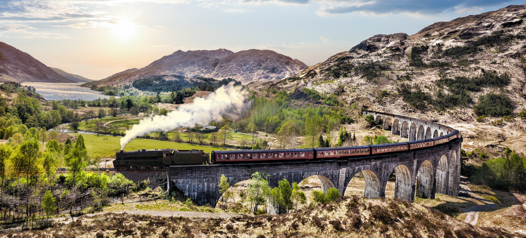 The Jacobite steam train crossing Glenfinnan Viaduct in the Scottish Highlands