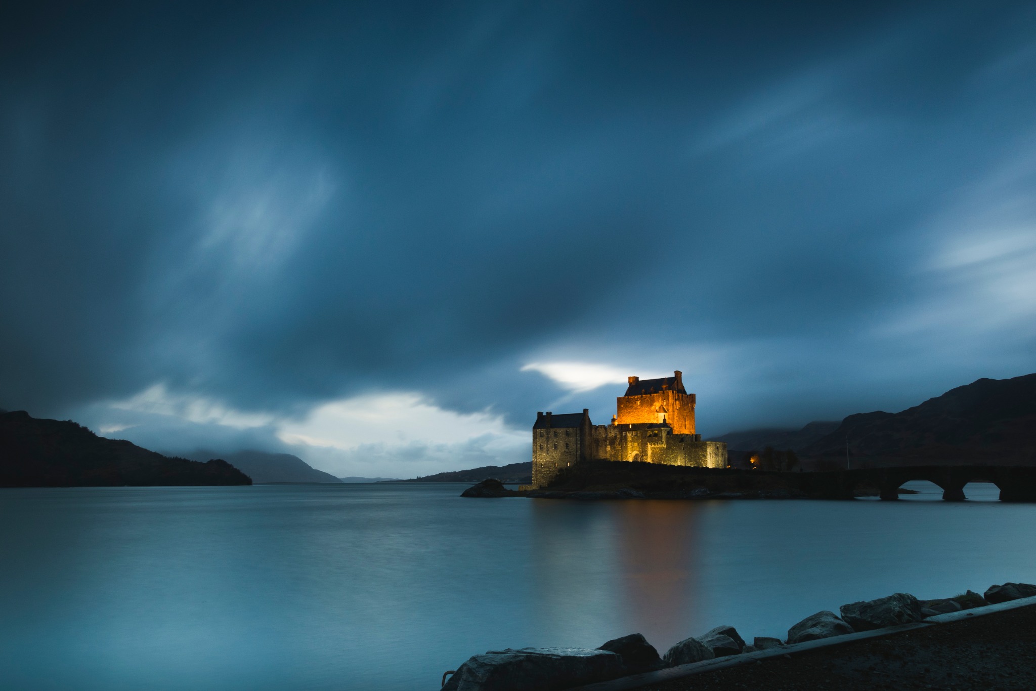 Eilean Donan Castle reflected in the water at blue hour