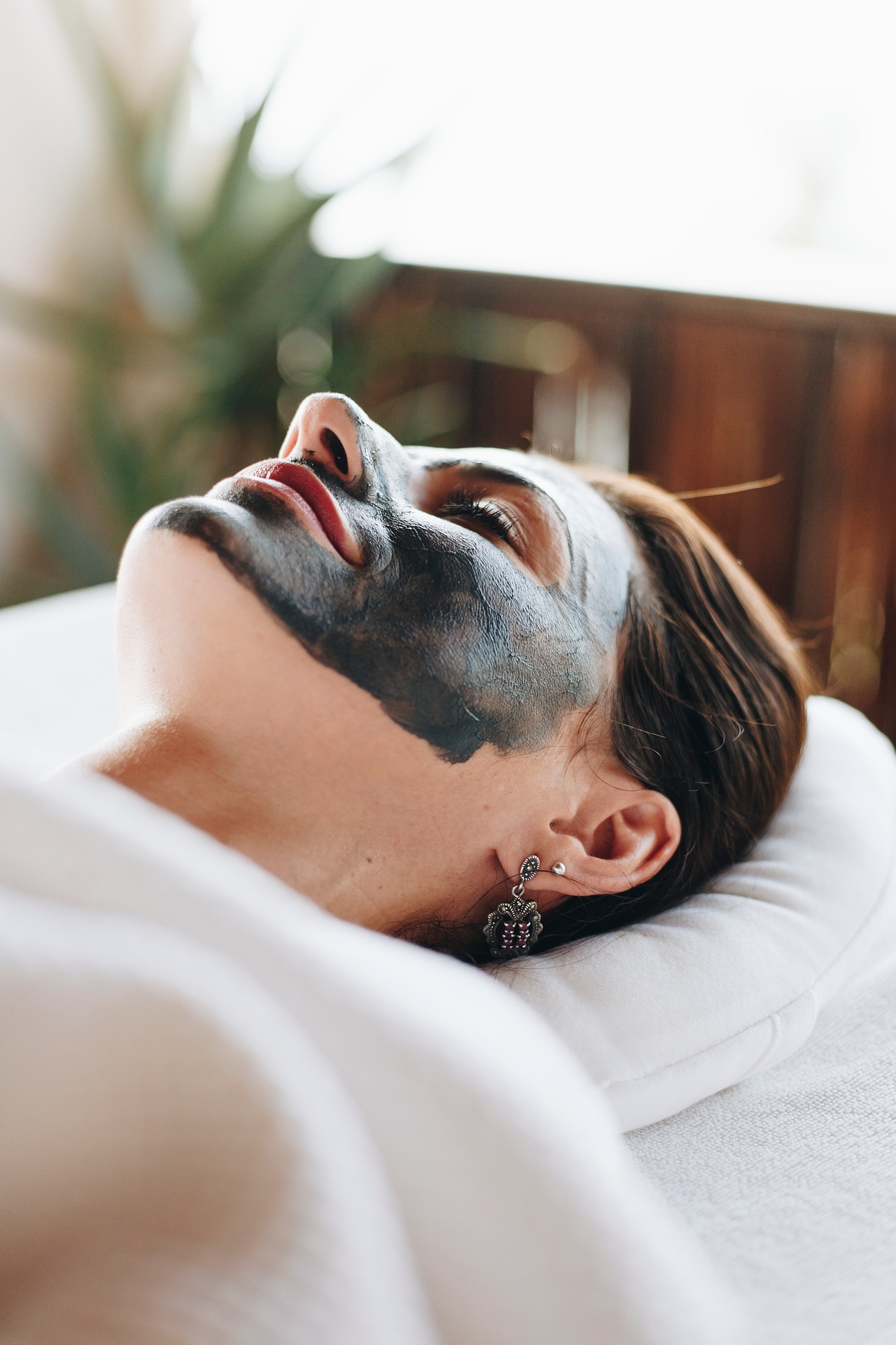 A guest relaxing during a calming facial spa treatment
